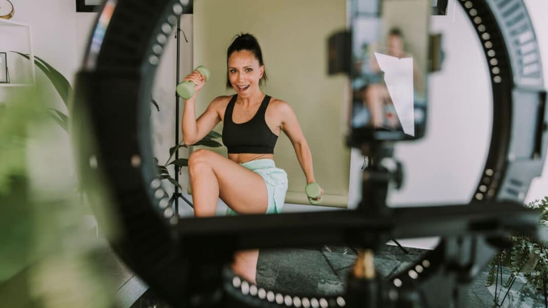 Fitness influencer working out in front of camera and in need of fitness certification